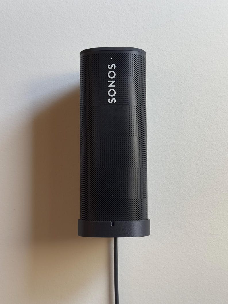 Black Sonos Roam installed vertically on the black SPEKURA cable wall mount